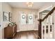 Elegant entryway with wood floors, double doors, and staircase at 7708 S Krameria Ct, Centennial, CO 80112