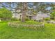 Charming home featuring a lush front yard with mature trees and manicured landscaping at 7708 S Krameria Ct, Centennial, CO 80112