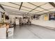 The garage has storage shelves, epoxy floors, ample space, and overhead lighting at 7708 S Krameria Ct, Centennial, CO 80112