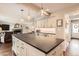 Open-concept kitchen with large island, modern lighting, and seamless connection to the living area at 7708 S Krameria Ct, Centennial, CO 80112