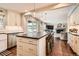 Spacious kitchen with large island, modern appliances, and an open layout to the living room at 7708 S Krameria Ct, Centennial, CO 80112