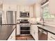 Kitchen features stainless steel appliances, white cabinets, tile backsplash, and a farmhouse sink at 7708 S Krameria Ct, Centennial, CO 80112