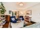 Cozy living room featuring comfortable seating, piano, and open access to dining area at 7708 S Krameria Ct, Centennial, CO 80112