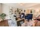 Bright living room with stylish decor, shelving, and a view into the dining room at 7708 S Krameria Ct, Centennial, CO 80112