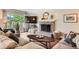 Stylish living room showcases a brick fireplace, wood floors, and comfortable seating at 7708 S Krameria Ct, Centennial, CO 80112