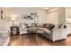 Comfortable living room with a large gray sectional, wood floors, and stylish decor at 7708 S Krameria Ct, Centennial, CO 80112
