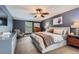 Spacious main bedroom with dark blue walls, a ceiling fan, and comfortable furnishings at 7708 S Krameria Ct, Centennial, CO 80112