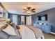 Relaxing main bedroom showcases a ceiling fan, cozy bedding, and ensuite bath access at 7708 S Krameria Ct, Centennial, CO 80112