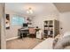 This home office has a desk with a computer, a pink desk chair, overhead lighting, and a small window at 7708 S Krameria Ct, Centennial, CO 80112