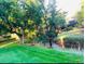 Scenic backyard with lush greenery, mature trees, and a tranquil creek at 8039 Lee Dr # 2, Arvada, CO 80005