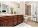 Well-lit bathroom with double vanity, tiled shower, and decorative accents at 8039 Lee Dr # 2, Arvada, CO 80005