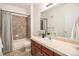 Bathroom with tiled shower/tub and a spacious vanity at 8039 Lee Dr # 2, Arvada, CO 80005
