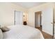 Bright bedroom featuring neutral colors, carpet, and access to the bathroom and closet at 8039 Lee Dr # 2, Arvada, CO 80005