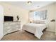 Bright bedroom with neutral tones, a large window, and a classic dresser at 8039 Lee Dr # 2, Arvada, CO 80005