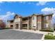 Attractive multi-unit building with a stone facade and private balconies, fronted by parking at 8039 Lee Dr # 2, Arvada, CO 80005