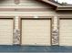 Attached multi-car garage featuring neutral paint, decorative rock accents, and prominent unit number at 8039 Lee Dr # 2, Arvada, CO 80005