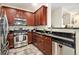 Modern kitchen featuring stainless steel appliances, dark countertops and tile flooring at 8039 Lee Dr # 2, Arvada, CO 80005