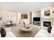 Bright living room features a modern fireplace, TV, stylish furniture, and an open view into the kitchen at 8039 Lee Dr # 2, Arvada, CO 80005