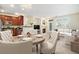 Open-concept living space featuring a fireplace, dining area with chandelier, and modern kitchen with dark cabinets at 8039 Lee Dr # 2, Arvada, CO 80005