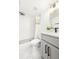 Clean bathroom with white tile, modern fixtures, a shower with patterned tile, and a vanity at 11710 Spruce Canyon Cir, Golden, CO 80403