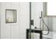 Modern bathroom featuring light tile, a built-in shelf, and a shower with sleek, dark fixtures at 11710 Spruce Canyon Cir, Golden, CO 80403