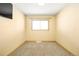 Cozy bedroom with neutral walls, carpet, a bright window and a mounted TV at 11710 Spruce Canyon Cir, Golden, CO 80403