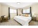Bright bedroom with neutral tones, a plush bed, and a cozy chair, creating a relaxing atmosphere at 11710 Spruce Canyon Cir, Golden, CO 80403