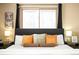 Serene bedroom with large windows, decorative pillows, and ambient lighting for a peaceful retreat at 11710 Spruce Canyon Cir, Golden, CO 80403