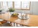 A close-up shot of a dining table with a decorative centerpiece, glassware, and a view of the outdoors at 11710 Spruce Canyon Cir, Golden, CO 80403