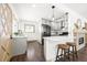 Bright kitchen with stainless steel appliances, stone fireplace, breakfast bar and dark hardwood flooring at 11710 Spruce Canyon Cir, Golden, CO 80403