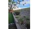 Backyard garden featuring mature landscaping, stone retaining wall, and wood fence line at 1815 Avery Way, Castle Rock, CO 80109