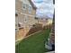 Fenced backyard with artificial turf, side of house, and stone accents at 1815 Avery Way, Castle Rock, CO 80109