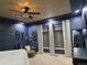 Primary bedroom boasts modern ceiling fan, blue walls, recessed lighting, and floor-to-ceiling window treatments at 1815 Avery Way, Castle Rock, CO 80109