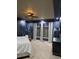 Primary bedroom boasts modern ceiling fan, blue walls, recessed lighting, and floor-to-ceiling window treatments at 1815 Avery Way, Castle Rock, CO 80109