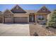 Charming home featuring a two-car garage, stone accents, covered front porch, and well-maintained landscaping at 1815 Avery Way, Castle Rock, CO 80109