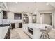 Kitchen with stainless appliances, large island, and dark cabinets at 1815 Avery Way, Castle Rock, CO 80109