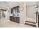 Elegant kitchen area with dark cabinetry, lighting, and plenty of storage provides style and functionality at 1815 Avery Way, Castle Rock, CO 80109