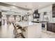 Open kitchen layout with stainless appliances, island with seating, and pendant lighting at 1815 Avery Way, Castle Rock, CO 80109