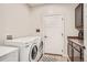 Functional laundry area features appliances and cabinet space for storage and organization at 1815 Avery Way, Castle Rock, CO 80109