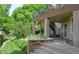 Well-maintained backyard features a patio with columns, a stone wall, flowers, and a cozy seating area at 2819 Canyon Crest Dr, Highlands Ranch, CO 80126