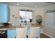 Wet bar area featuring granite countertops, updated lighting, and blue cabinets at 2819 Canyon Crest Dr, Highlands Ranch, CO 80126