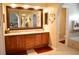 Large bathroom boasts double sinks, granite countertops, a large framed mirror and arched entryways at 2819 Canyon Crest Dr, Highlands Ranch, CO 80126