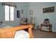 Charming bedroom with blue accents, teddy bear decor, and a window with decorative curtains at 2819 Canyon Crest Dr, Highlands Ranch, CO 80126
