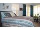 Comfortable bedroom with a colorful bed, an outdoor patio, and bright light at 2819 Canyon Crest Dr, Highlands Ranch, CO 80126