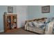 Comfortable bedroom with a bookshelf, a bed with a blue and white quilt, and a window at 2819 Canyon Crest Dr, Highlands Ranch, CO 80126