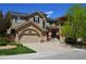 Charming two-story home with a well-manicured lawn, a two-car garage, and a welcoming entrance with an American flag at 2819 Canyon Crest Dr, Highlands Ranch, CO 80126