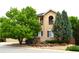 Charming two-story home with stucco exterior and mature landscaping at 2819 Canyon Crest Dr, Highlands Ranch, CO 80126