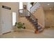 Grand foyer showcasing a staircase with decorative iron railings and neutral tile flooring at 2819 Canyon Crest Dr, Highlands Ranch, CO 80126