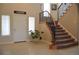 Elegant foyer with tile flooring, staircase with iron railing, and bright natural light from windows around the front door at 2819 Canyon Crest Dr, Highlands Ranch, CO 80126