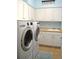 Convenient laundry room with washer, dryer, sink, and ample cabinet space at 2819 Canyon Crest Dr, Highlands Ranch, CO 80126